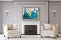 a living room with two chairs and a painting on the wall